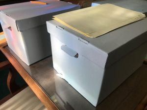 Two boxes sitting on a table. 