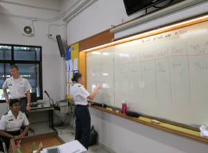A Thai cadet participates in class, learning new English vocabulary and grammar. 