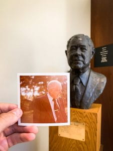 Photograph of Bob Poage juxtaposed with a bust of the library's namesake.