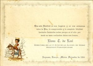 A child in traditional Mexican clothing sits atop a burro (donkey) carrying a gold chest and wearing a gold crown in front of two trees. The image is in the lower left corner of a Christmas card with well wished written in Spanish. 