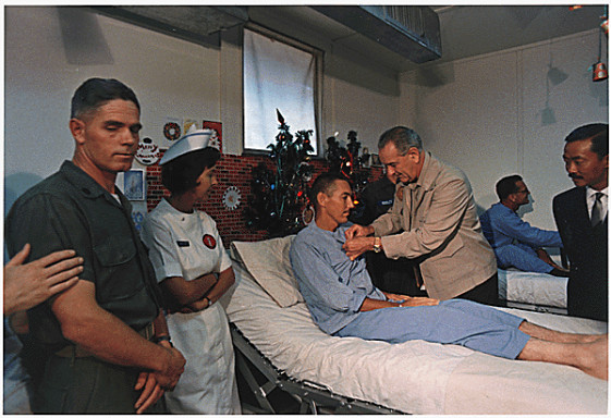  President Lyndon B. Johnson in Vietnam: Decorating a soldier in a hospital.