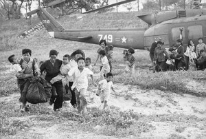 Vietnamese refugees run for a rescue helicopter to evacuate them to safety. (Bettmann/ Corbis)
